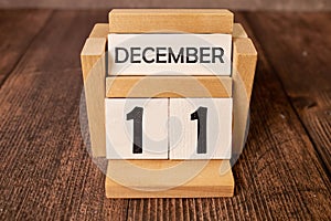 December 11 text on wooden blocks with blurred nature background. Copy space and calendar concept
