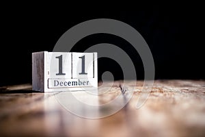 December 11th, 11 December, Eleventh of December - White block calendar on vintage table - Date on dark background