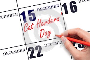 December 15. Hand writing text Cat Herders Day on calendar date. Save the date.