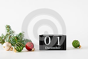 December 1st. Day 1 of december month, calendar with christmas balls decoration and fir branches on white background. Winter time