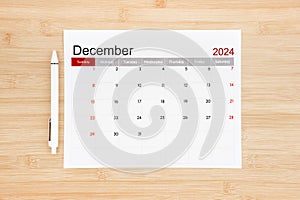 December 2024 calendar page on wooden