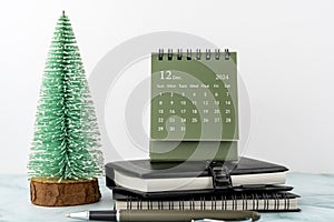 December 2024 desk calendar on top of table