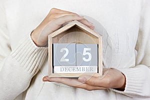 December 25 in the calendar. the girl is holding a wooden calendar. Boxing Day, St. Stephen's Day