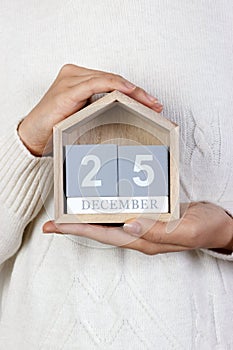 December 25 in the calendar. the girl is holding a wooden calendar. Boxing Day, St. Stephen's Day