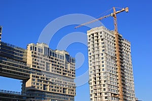 December 5, 2020 Moscow, Russia. Crane and building construction site against blue sky