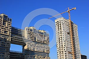 December 5, 2020 Moscow, Russia. Crane and building construction site against blue sky