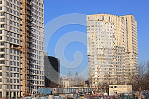 December 5, 2020 Moscow, Russia. Crane and building construction site against blue sky