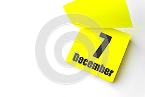 December 7th. Day 7 of month, Calendar date. Close-Up Blank Yellow paper reminder sticky note on White Background. Winter month,