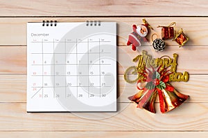 December calendar and Christmas decoration - Santa Clause and gift on wooden table. Christmas and Happy new year concept