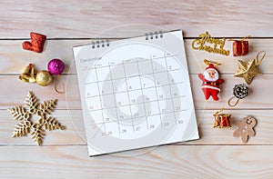 December calendar and Christmas decoration - Santa Clause and gift on wooden table. Christmas and Happy new year concept