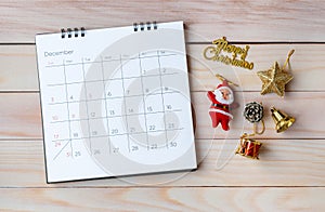 December calendar and Christmas decoration - Santa Clause and gift on wooden table. Christmas and Happy new year concept