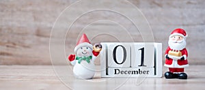 1 December calendar with Christmas decoration, snowman, Santa claus and pine tree  on wooden table background, preparation for