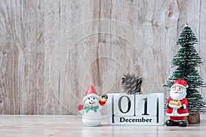 1 December calendar with Christmas decoration, snowman, Santa claus and pine tree  on wooden table background, preparation for