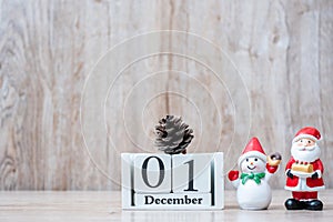 1 December calendar with Christmas decoration, snowman, Santa claus and pine tree  on wooden table background, preparation for