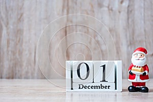 1 December calendar with Christmas decoration, snowman, Santa claus and pine tree  on wooden table background, preparation for