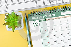 December 2021 desk calendar and diary with keyboard computer