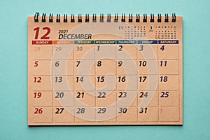 December 2021 desk calendar on green background