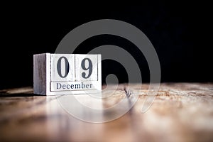 December 9th, 9 December, Nineth of December - White block calendar on vintage table - Date on dark background