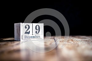 December 29th, 29 December, Twenty Nineth of December - White block calendar on vintage table - Date on dark background photo