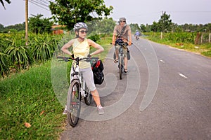 28 DECEMBER 2016, Vietnam, Can Txo. Two travelers on bicycles. Vietnamese tourism. Mekong Delta among rice fields