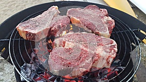 Decent size steaks over hot coals