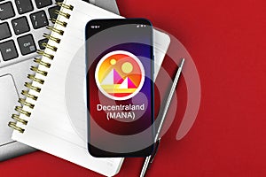 Decentraland MANA symbol. Trade with cryptocurrency, digital and virtual money, banking with mobile phone concept photo