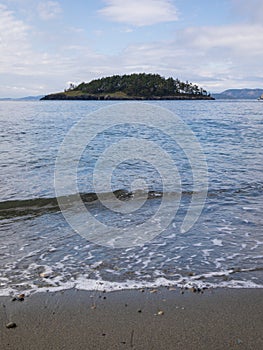 Deception Island rocky seashore and ocean view at Deception Pass State Park at Whidbey Island Washington during summer