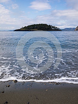 Deception Island rocky seashore and ocean view at Deception Pass State Park at Whidbey Island Washington during summer