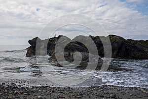 Deception Island rocky seashore and ocean view at Deception Pass State Park at Whidbey Island Washington during summer