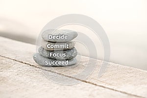 Decide, commit, focus and succeed. Motivational advice or reminder, on the stones