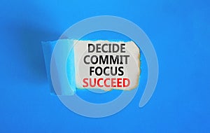 Decide commit focus succeed symbol. Concept word Decide Commit Focus Succeed on beautiful white paper. Beautiful blue paper