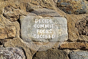 Decide commit focus succeed symbol. Concept word Decide Commit Focus Succeed on beautiful stone. Beautiful stone wall background.