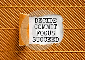 Decide commit focus succeed symbol. Concept word Decide Commit Focus Succeed on beautiful white paper. Beautiful brown paper