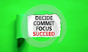 Decide commit focus succeed symbol. Concept word Decide Commit Focus Succeed on beautiful white paper. Beautiful green paper