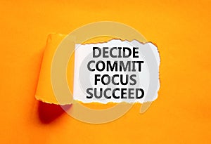 Decide commit focus succeed symbol. Concept word Decide Commit Focus Succeed on beautiful white paper. Beautiful orange paper