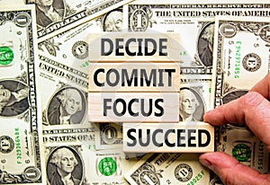 Decide commit focus succeed symbol. Concept word Decide Commit Focus Succeed on block. Dollar bills. Beautiful background from