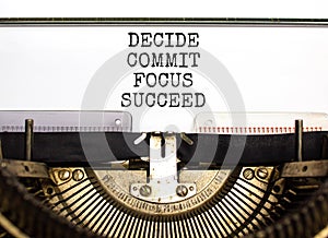 Decide commit focus succeed symbol. Concept word Decide Commit Focus Succeed typed on old retro typewriter. Beautiful white paper