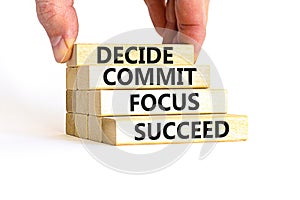Decide commit focus succeed symbol. Concept word Decide Commit Focus Succeed on wooden block. Beautiful white background.