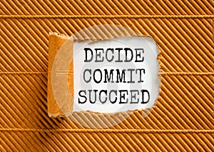 Decide commit succeed symbol. Concept word Decide Commit Succeed on beautiful white paper. Beautiful brown table brown background