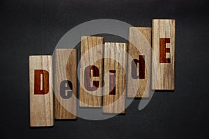 Decide word letters written on wooden blocks. Motivational business idea startup concept