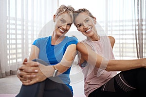 Decided to love ourselves, we dont care what youll do. Portrait of two women taking a break while exercising together at
