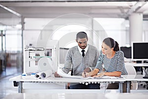 Deciding on the perfect new design. two colleagues talking together over a touchscreen computer while working with a 3d