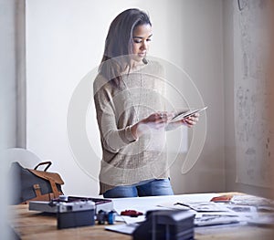 Deciding which images are portfolio worthy. A young woman selecting pictures to include in her portfolio.