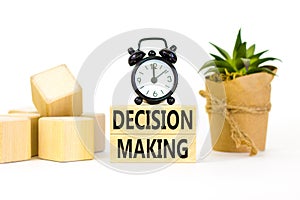 Decision making symbol. Concept words Decision making on wooden blocks. Beautiful white table white background. Black alarm clock