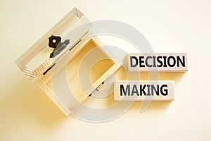 Decision making symbol. Concept words Decision making on wooden blocks. Beautiful white table white background. Empthy wooden