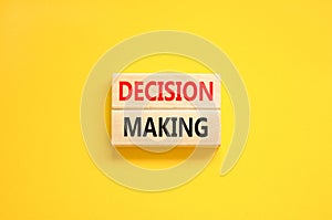 Decision making symbol. Concept words Decision making on wooden blocks. Beautiful yellow table yellow background. Business and