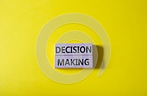 Decision making symbol. Wooden blocks with words Decision making. Beautiful yellow background. Business and Decision making
