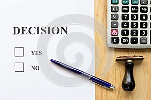 Decision paper with yes and no choice, pen, rubber stamp