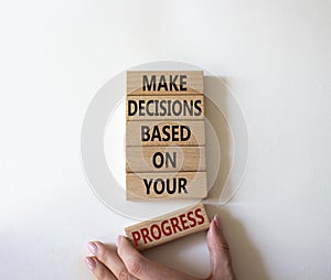 Decision and Progress symbol. Concept words Make decisions based on your progress on wooden blocks. Businessman hand. Beautiful