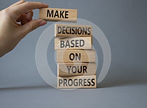 Decision and Progress symbol. Concept words Make decisions based on your progress on wooden blocks. Businessman hand. Beautiful